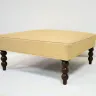 Ottoman with Carved Wooden Legs Recovered in a Printed Fabric