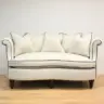 Curved Sofa Reupholstered in a Cream Fabric with Dark Contrast Piping