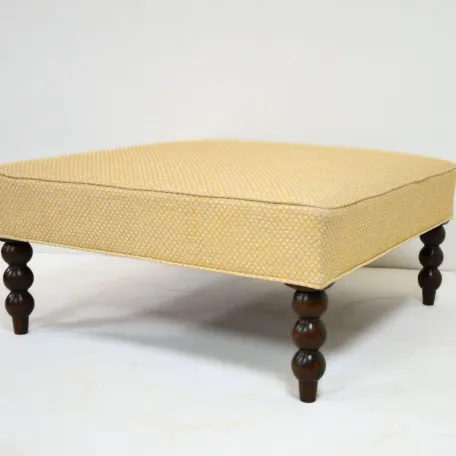 Ottoman with Carved Wooden Legs Recovered in a Printed Fabric