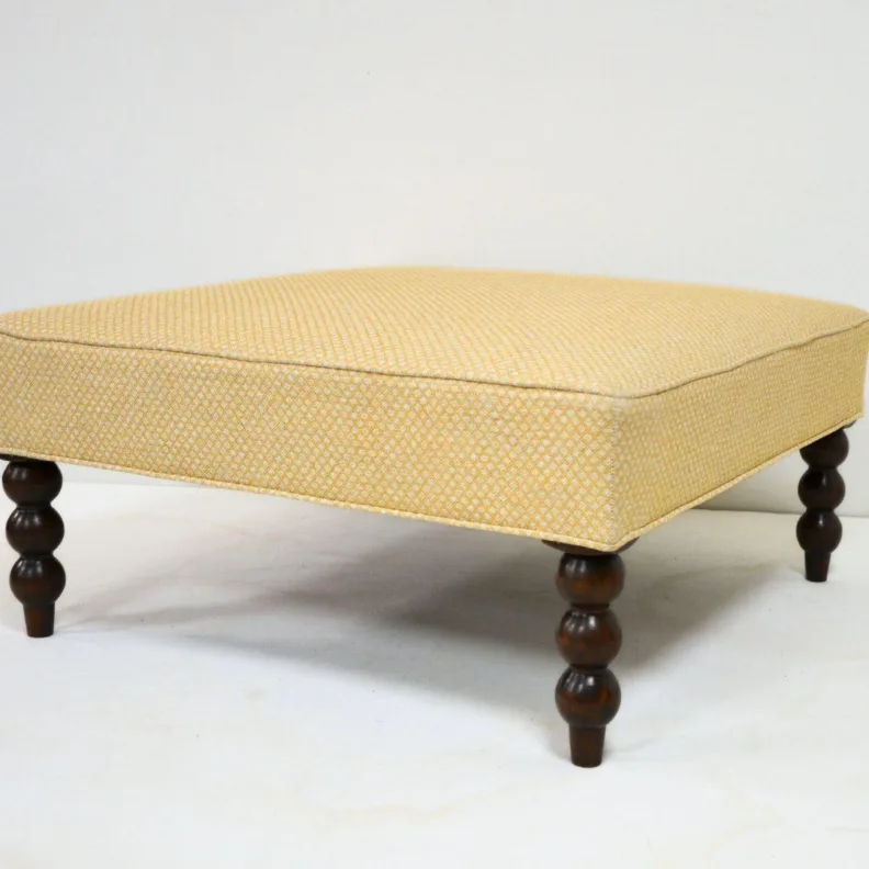 Ottoman with Carved Wooden Legs Recovered in a Printed Fabric