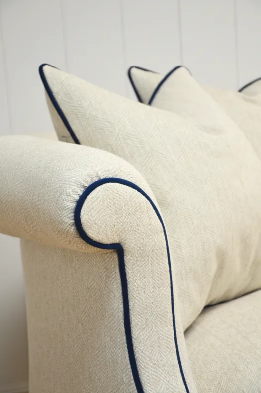 Curved Sofa Reupholstered in a Cream Fabric with Dark Contrast Piping