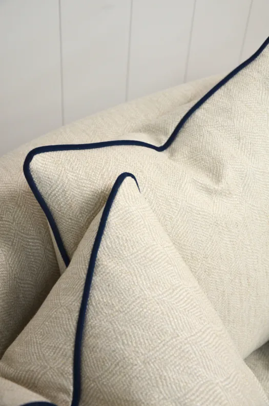 Curved Sofa Reupholstered in a Cream Fabric with Dark Contrast Piping