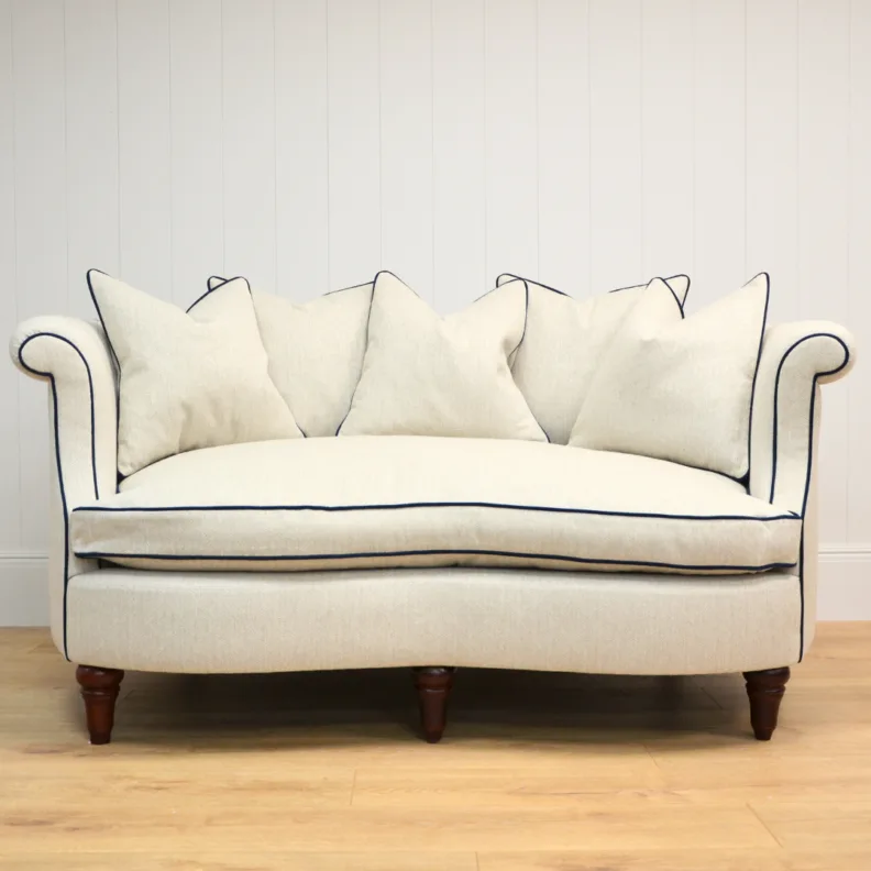 Curved Sofa Reupholstered in a Cream Fabric with Dark Contrast Piping